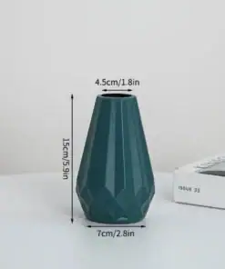 Blue geometric vase with dimensions: 15cm/5.9in tall, 7cm/2.8in wide, 4.5cm/1.8in top. Placed near a book. | 28Alchemy