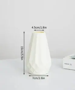 White ceramic vase with geometric design, 15cm tall, on a round table near a partially visible magazine. | 28Alchemy