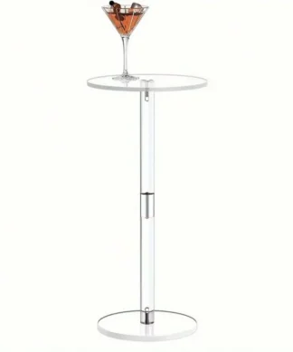A martini glass with a drink sits on a tall, modern white round side table with a metal accent. | 28Alchemy
