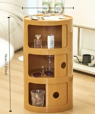 A small, round, brown storage cabinet with three compartments, measuring 58cm tall and 32cm wide, in a living room. | 28Alchemy