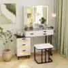 Modern vanity table with mirror, stool, makeup, drawers, shelves, and soft lighting in a stylish, cozy room. | 28Alchemy