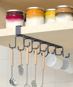 Utensil rack with wooden-handle tools and mugs hanging under a shelf with jars on top. | 28Alchemy
