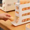 A hand takes an egg from a white plastic egg dispenser on a kitchen counter near an oven. | 28Alchemy