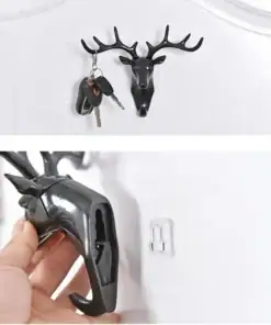 Black deer head wall hook holding keys, shown both in use and being mounted on a white wall with an adhesive hook. | 28Alchemy