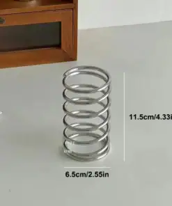 A metal coil spring, 11.5 cm tall and 6.5 cm wide, sits upright on a light-colored surface. | 28Alchemy