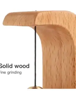 Close-up of a smooth, curved solid wood object with a string hanging down, labeled "Solid wood, Fine grinding. | 28Alchemy