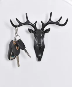 A black deer head wall hook holding a set of keys with a black key fob and two metal keys. | 28Alchemy
