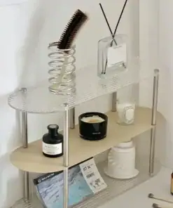 A small, modern shelf holds candles, a brush in a spring holder, reed diffuser, bottles, and a magazine. | 28Alchemy