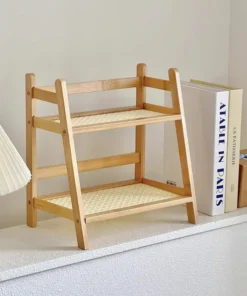 A small two-tier wooden shelf sits beside books, a lamp, and decor on a white ledge in a bright room. | 28Alchemy