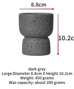 A dark gray, textured candle holder, 8.8cm wide and 10.2cm tall, with text listing its size and capacity. | 28Alchemy