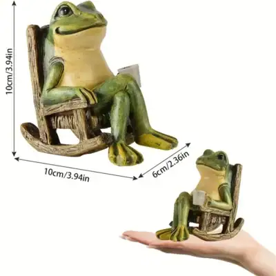 A small frog figurine sits in a rocking chair holding a cup, shown on a hand for scale with measurements labeled. | 28Alchemy