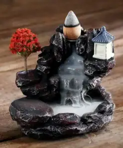 Miniature incense waterfall burner with a red tree, lantern, and smoke cascading down rocky steps on a wooden surface. | 28Alchemy