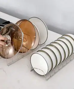 Two metal racks holding pot lids and white plates on a kitchen counter, with a hand reaching for a lid. | 28Alchemy