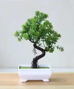 A small, artificial bonsai tree with green leaves in a white rectangular pot on a wooden surface. | 28Alchemy