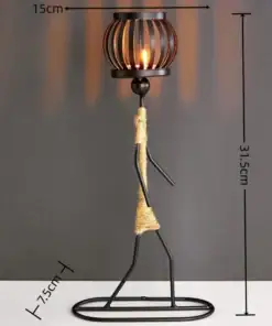 Minimalist metal candle holder shaped like a person, with a lit candle on top and dimensions labeled. | 28Alchemy
