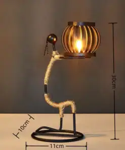 Modern decorative lamp shaped like a seated figure, 30cm tall, holding a lit lantern on a flat surface. | 28Alchemy