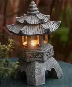 A stone lantern with a lit candle inside stands in the rain, surrounded by plants. | 28Alchemy