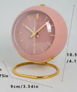 Pink round clock with gold hands and stand, shown with measurements: 10.5cm tall, 7cm deep, and 9cm wide. | 28Alchemy