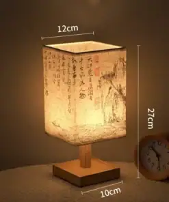 A rectangular table lamp with Chinese calligraphy, 27cm tall, beside a round clock on a table. | 28Alchemy