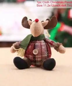Stuffed reindeer Christmas ornament with a plaid body, green scarf, and black feet, sitting on a table. | 28Alchemy