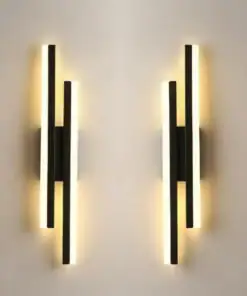 Two modern wall sconces with vertical black bars and glowing white light strips, mounted on a light-colored wall. | 28Alchemy