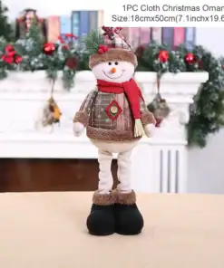 A plush snowman ornament with plaid clothes and a hat stands on a table in front of a fireplace decorated for Christmas. | 28Alchemy
