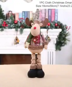 Plush reindeer Christmas ornament in festive clothes stands in front of a decorated fireplace with garland and books. | 28Alchemy