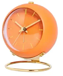 Orange, round retro-style clock with gold hands and gold stand, set against a white background. | 28Alchemy