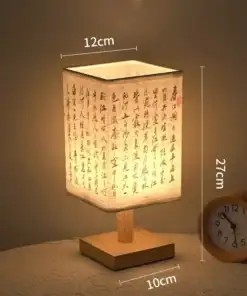 A square table lamp with Chinese calligraphy, measuring 27cm tall, 12cm wide, on a 10cm wooden base, beside a clock. | 28Alchemy