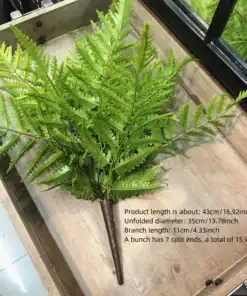 Artificial fern bunch with bright green leaves, product dimensions and details listed beside the plant on a wooden tray. | 28Alchemy