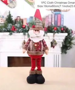 Plush Santa doll Christmas ornament with red hat, plaid shirt, and red pants, standing in a festive indoor setting. | 28Alchemy