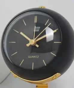 Round black and gold quartz desk clock with gold hands and numbers, showing the time as 10:10. | 28Alchemy