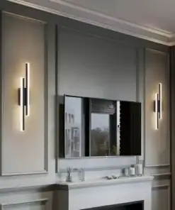 Modern living room with wall sconces, a mounted TV, and decorative trim on light gray walls above a white fireplace mantel. | 28Alchemy