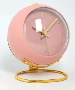 A pink and gold round desk clock with gold hands and stand, displayed against a white background. | 28Alchemy