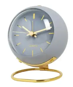 Round gray table clock with gold hands, hour marks, and a gold stand, showing the time as 10:09. | 28Alchemy