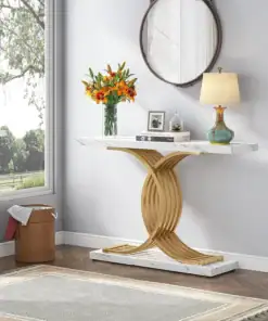 Modern entryway with a gold and marble console table, lamp, orange flowers, round mirror, and large window. | 28Alchemy