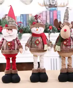 Three plush holiday dolls—Santa, a snowman, and a reindeer—stand side by side in festive clothing on a table. | 28Alchemy