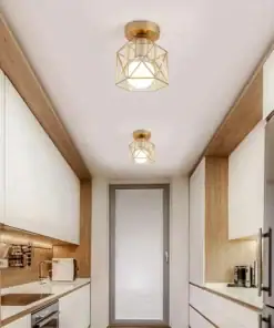 Modern kitchen with wood and white cabinets, stainless steel appliances, and two gold geometric ceiling lights. | 28Alchemy