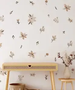 A wooden table and vase are against a white wall with beige and brown floral decals, near a staircase. | 28Alchemy