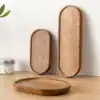Three wooden trays of different sizes on a wooden surface, with a glass jar and plant leaves in the background. | 28Alchemy