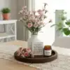 A vase of pink flowers, a candle, and a friendship quote sit on a wooden tray atop a lace-covered table. | 28Alchemy