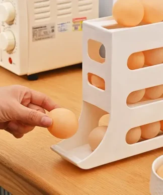 A hand takes an egg from a white plastic egg dispenser on a kitchen counter near an oven. | 28Alchemy