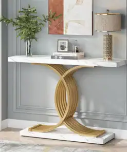 Elegant console table with a gold geometric base, marble top, lamp, plant, and decor against a gray paneled wall. | 28Alchemy