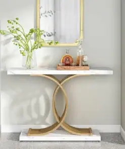 A marble console table with gold accents, a vase with green branches, and a tray with bottles and glasses below a mirror. | 28Alchemy