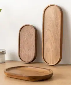 Three wooden trays of different sizes on a wooden surface, with a glass jar and plant leaves in the background. | 28Alchemy